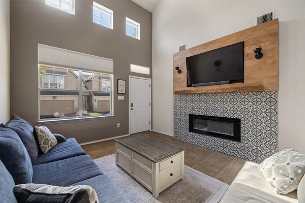 a living room with furniture and a fireplace