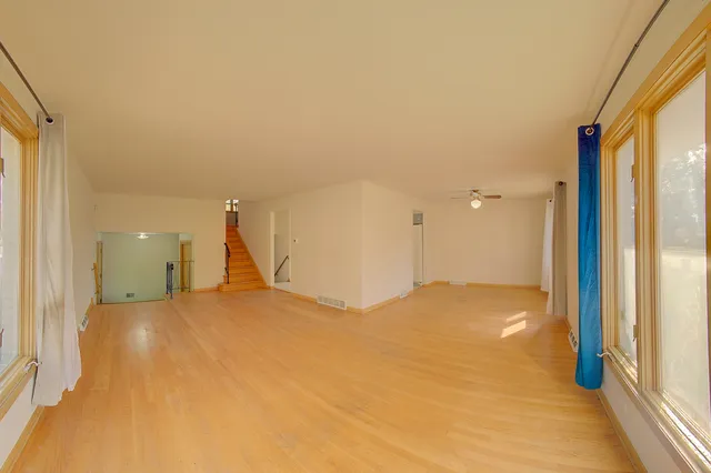 a view of empty room with a fireplace