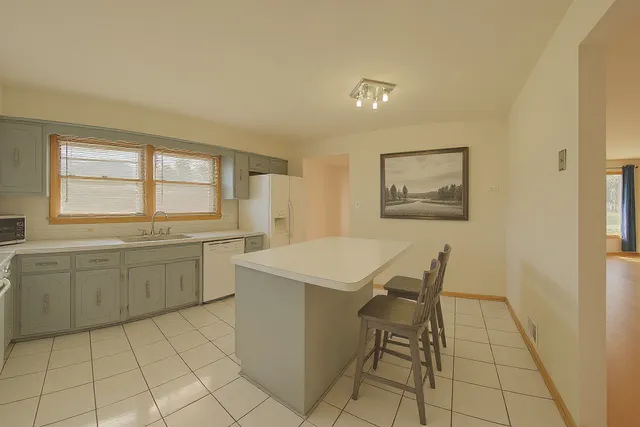 a kitchen with a cabinets and chairs