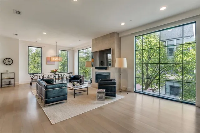 a living room with furniture large window and flat screen tv