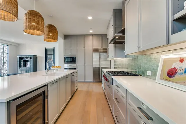a kitchen with a sink and a stove top oven