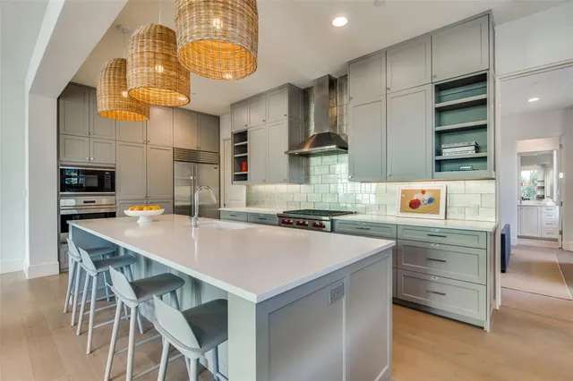 a kitchen with a sink a stove and chairs