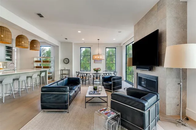 a living room with furniture a flat screen tv and a fireplace
