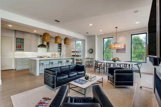 a living room with furniture and large windows