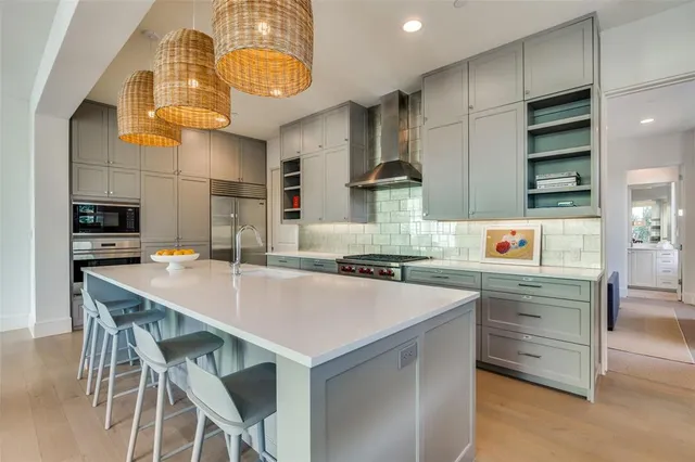 a kitchen with a sink a stove and chairs