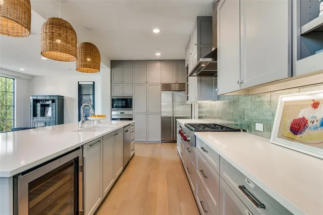 a kitchen with a sink and a stove top oven