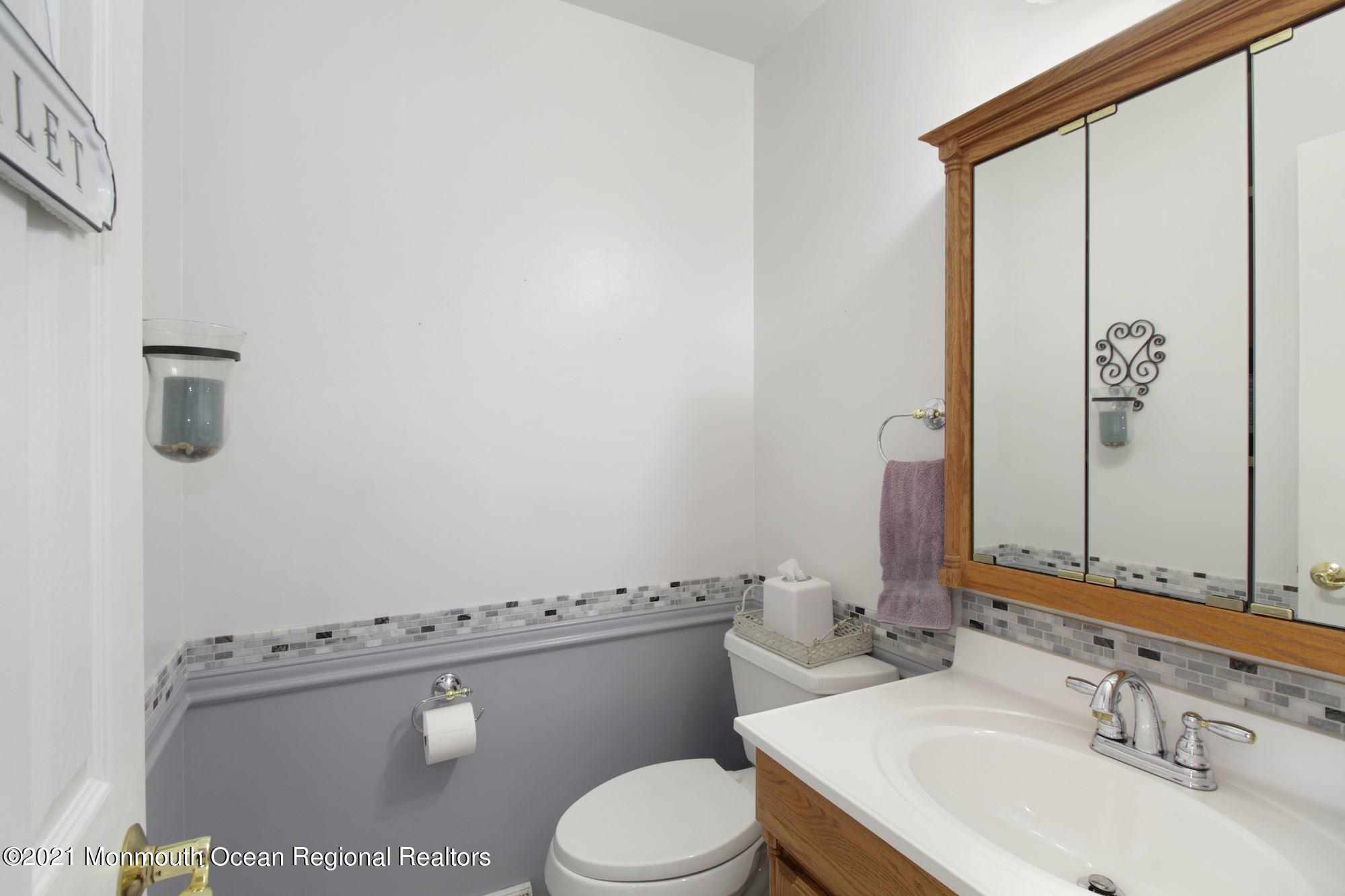 8 Derringer Drive Howell, NJ 07731 - Photo 11 of 33 a bathroom with a sink a toilet and mirror