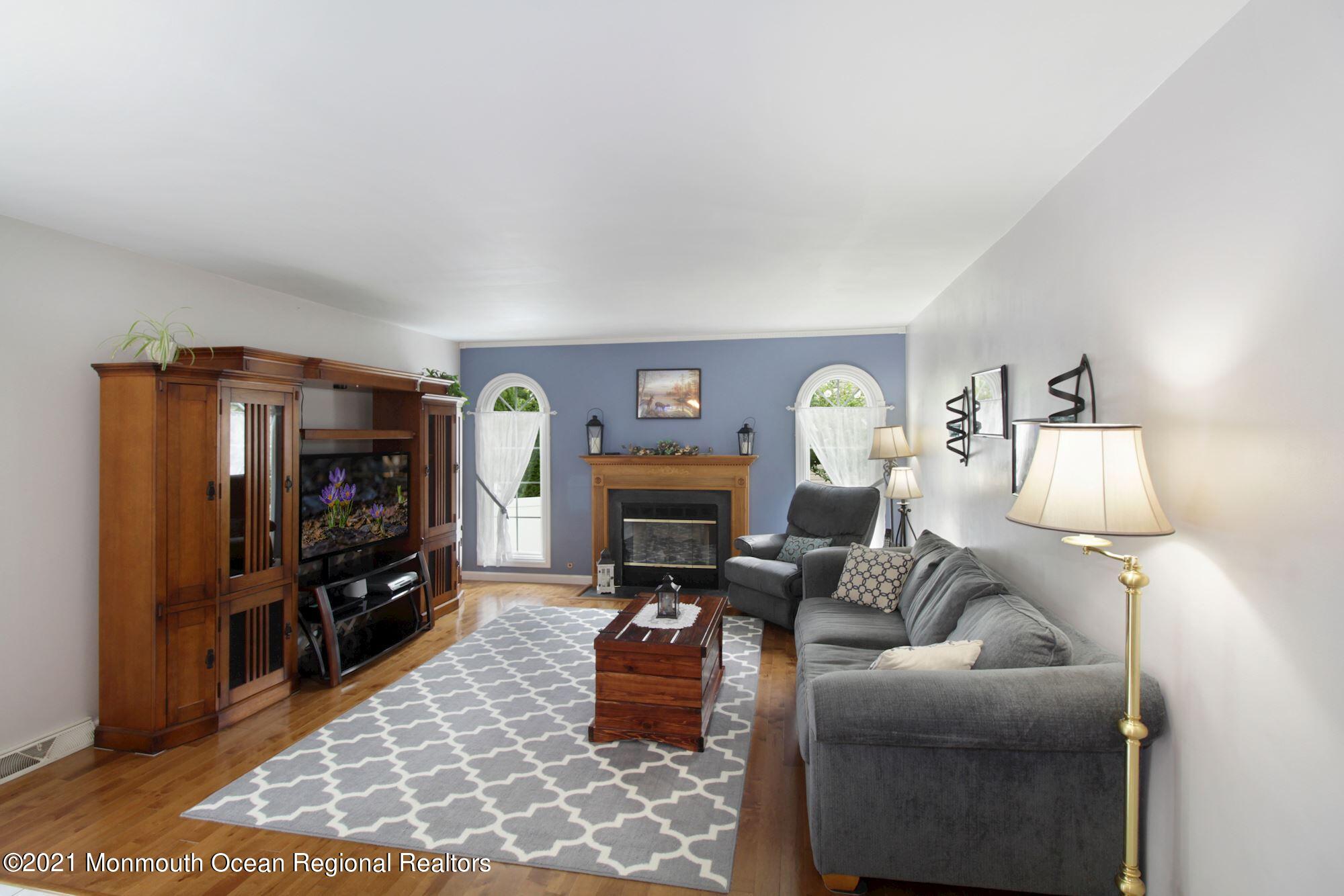 8 Derringer Drive Howell, NJ 07731 - Photo 12 of 33 a living room with furniture and a fireplace