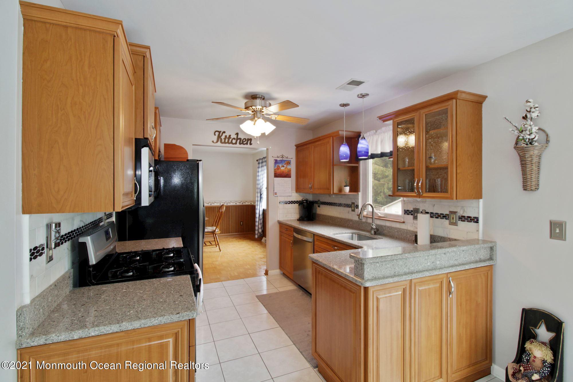 8 Derringer Drive Howell, NJ 07731 - Photo 15 of 33 a kitchen with stainless steel appliances granite countertop a sink stove and refrigerator