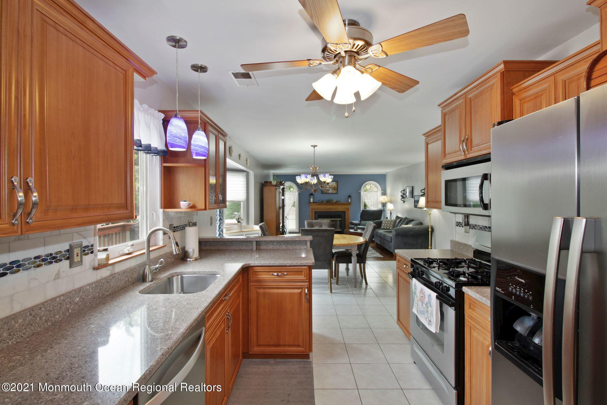 8 Derringer Drive Howell, NJ 07731 - Photo 18 of 33 a kitchen with stainless steel appliances granite countertop a sink a stove and a refrigerator