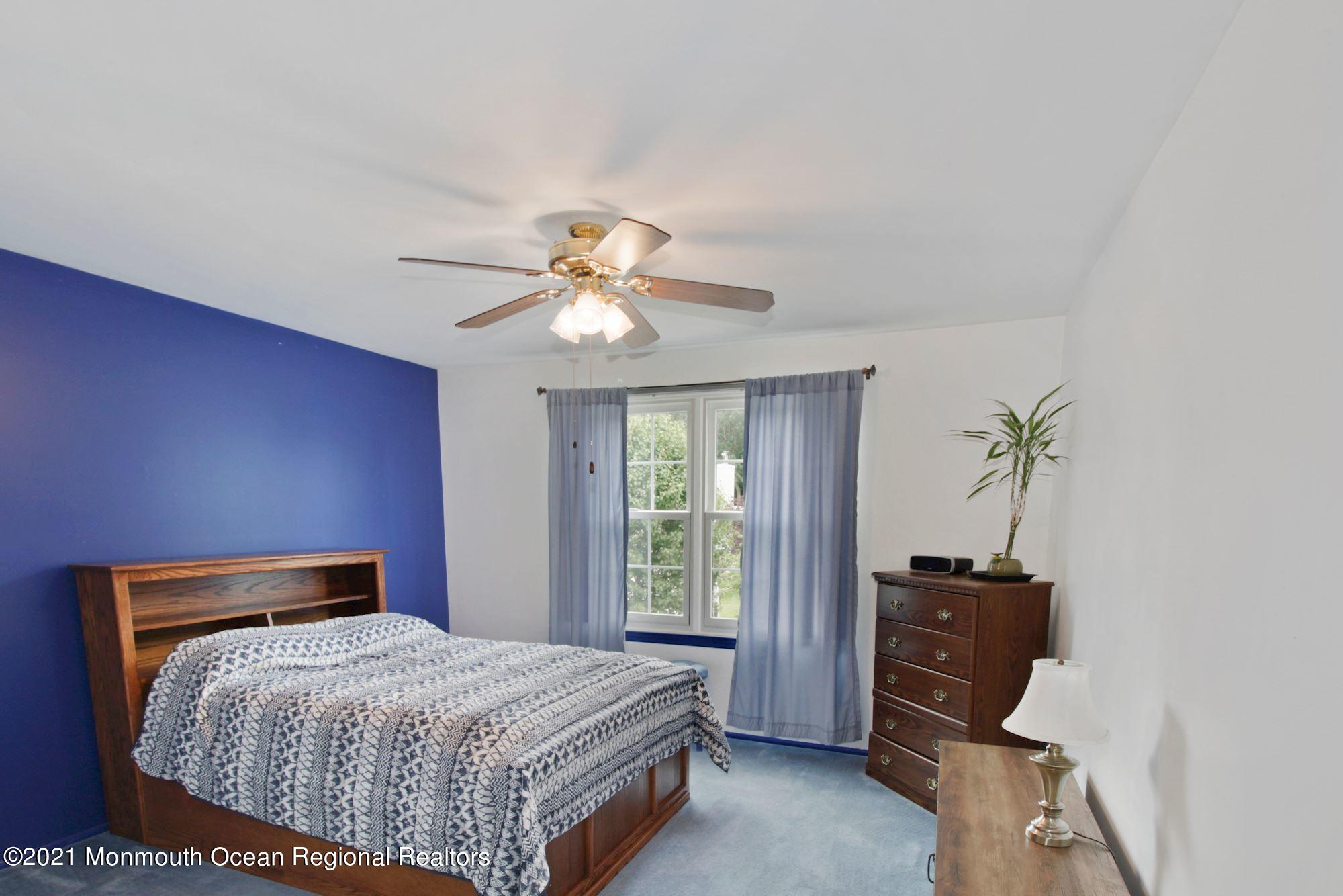 8 Derringer Drive Howell, NJ 07731 - Photo 19 of 33 a bedroom with a bed and a chandelier