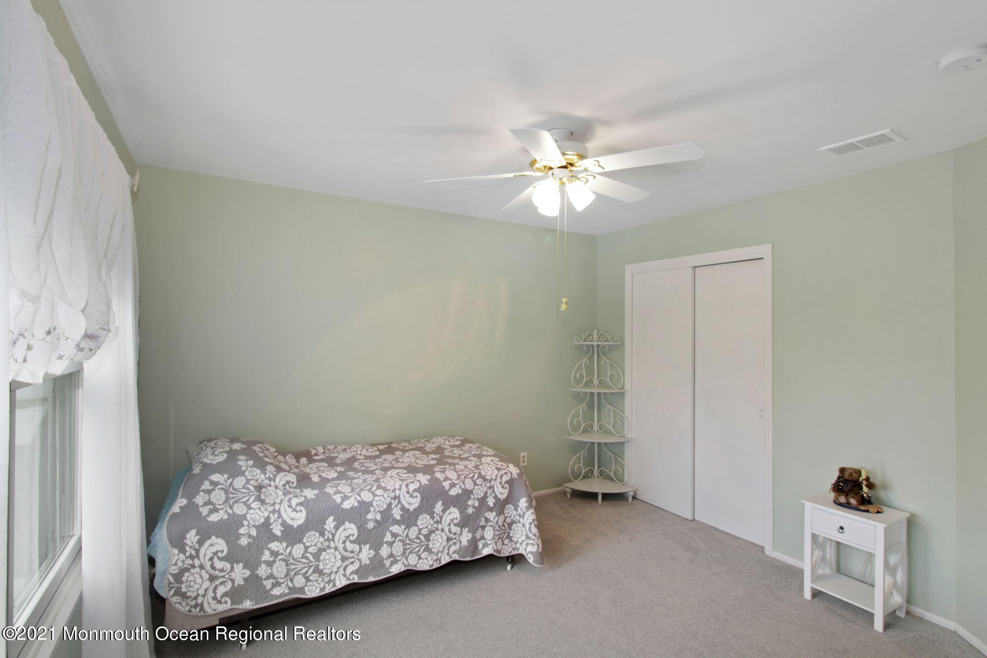 8 Derringer Drive Howell, NJ 07731 - Photo 21 of 33 a bedroom with a bed and a chandelier