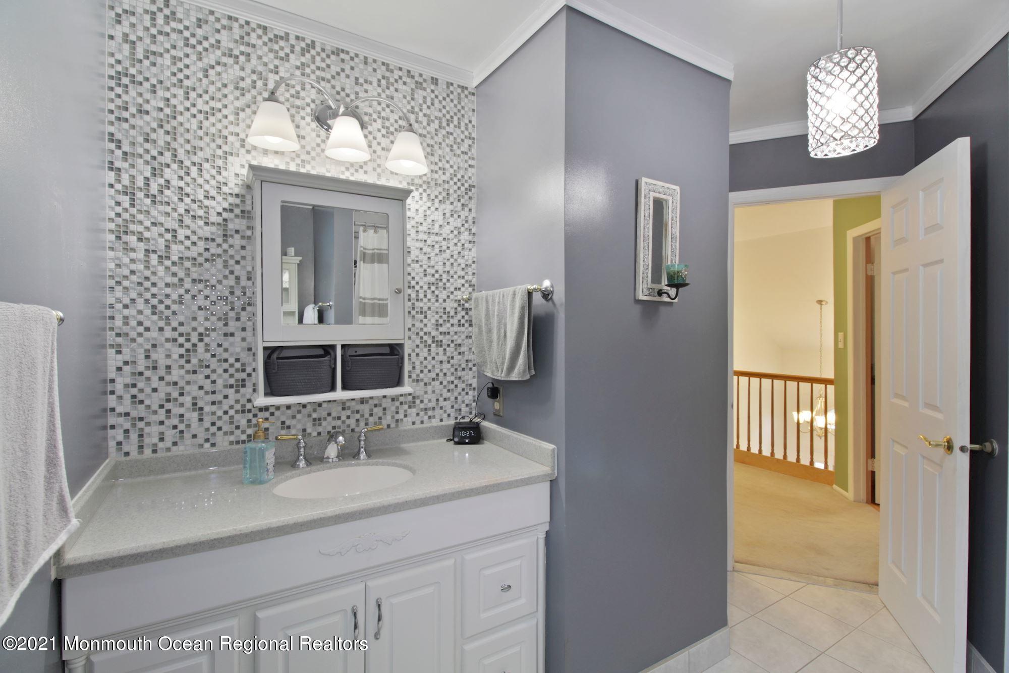 8 Derringer Drive Howell, NJ 07731 - Photo 23 of 33 a bathroom with a sink double vanity and a mirror