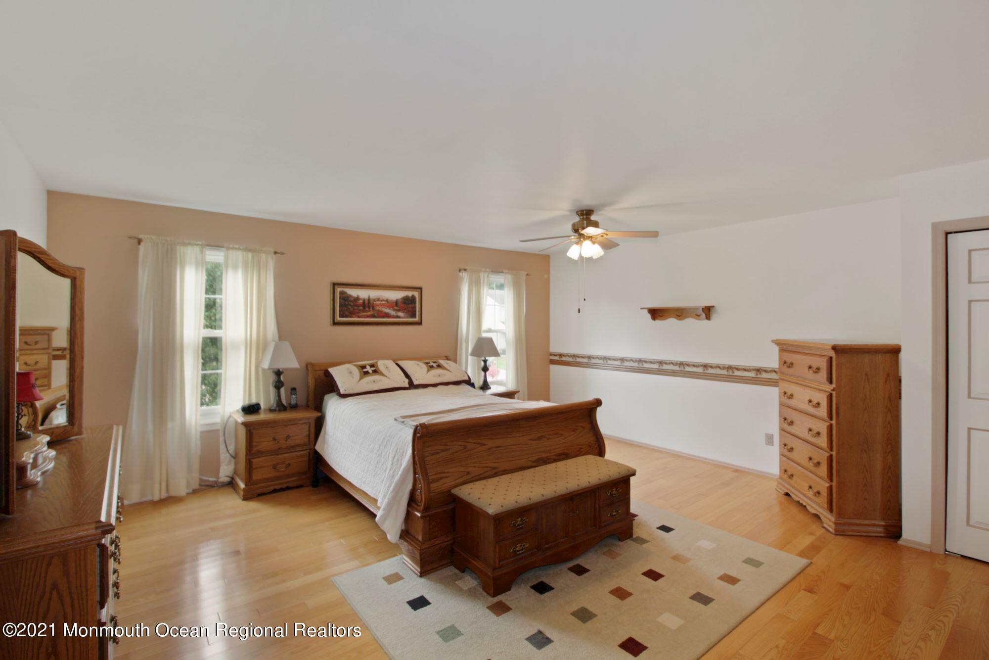 8 Derringer Drive Howell, NJ 07731 - Photo 26 of 33 a bed room with a bed and a chandelier