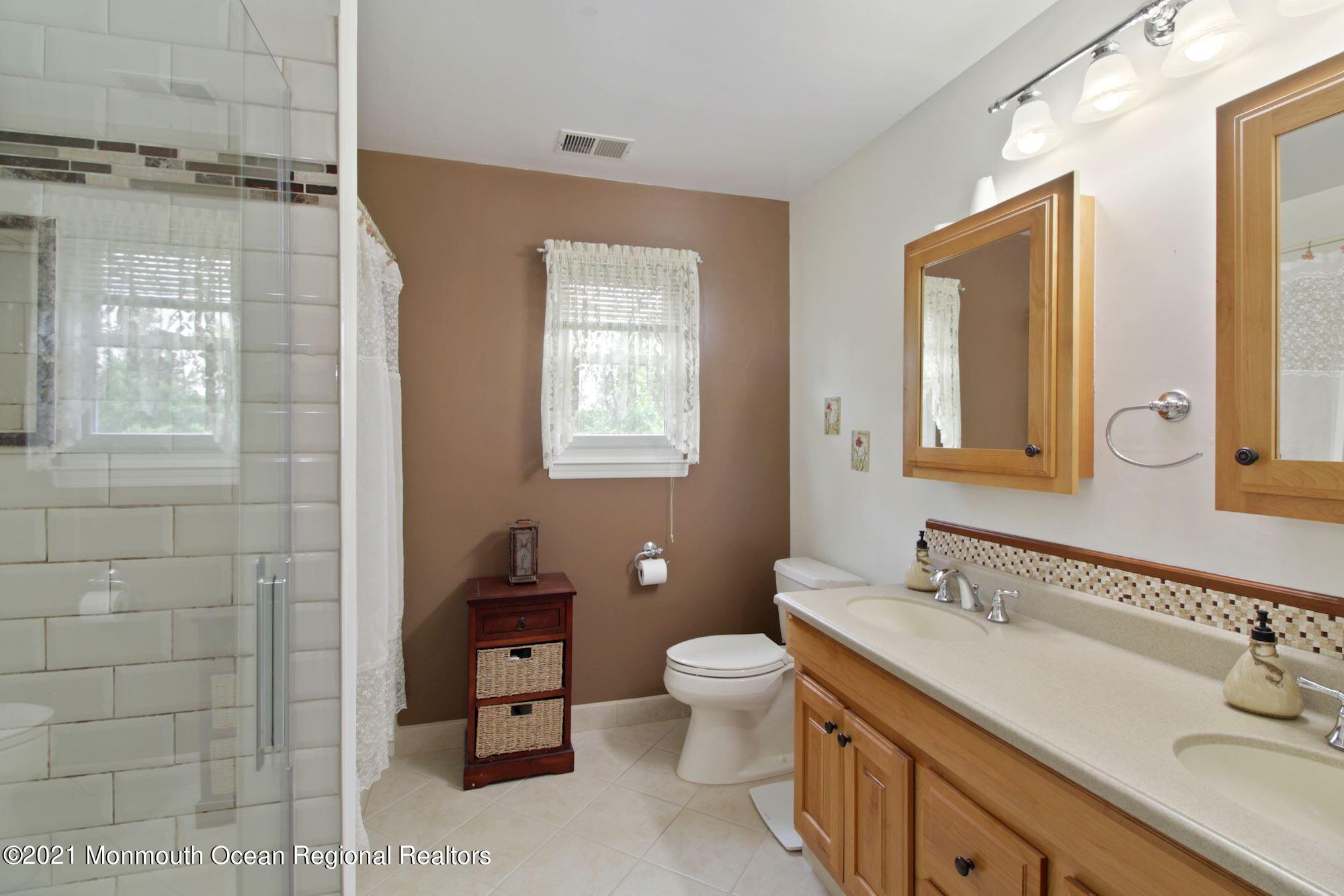 8 Derringer Drive Howell, NJ 07731 - Photo 29 of 33 a bathroom with a double vanity sink toilet and shower