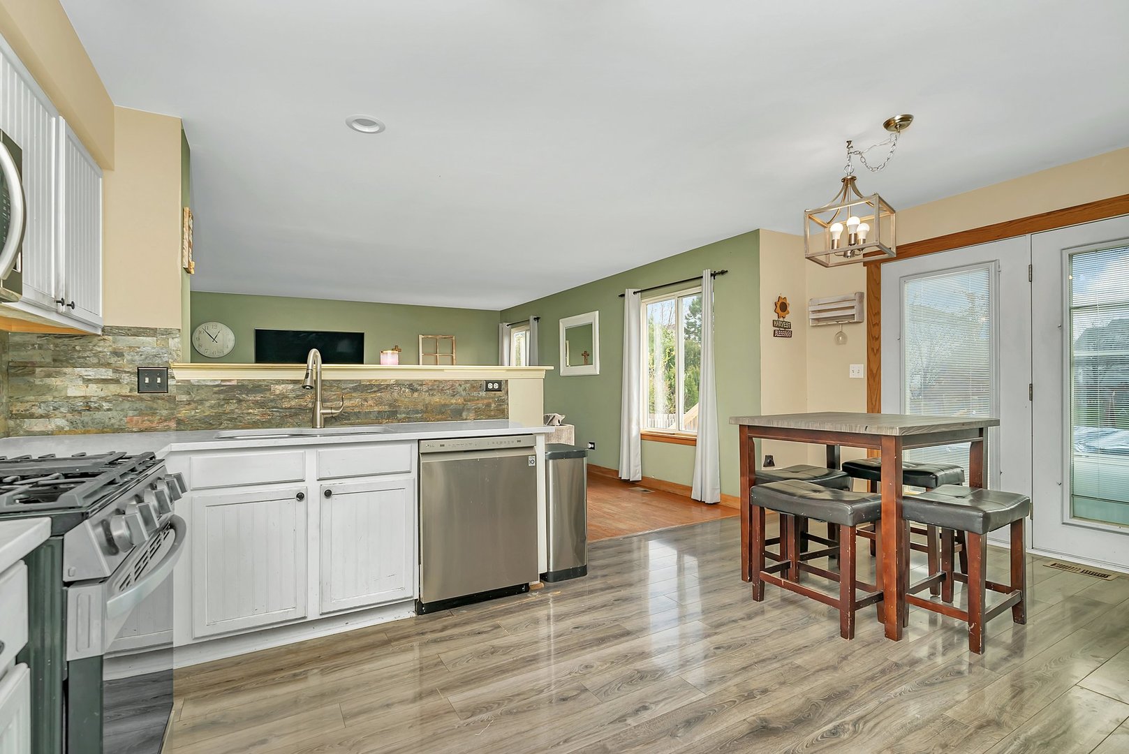 27039 West Hemlock Road Channahon, IL 60410 - Photo 12 of 41 a kitchen with granite countertop a stove chairs sink and cabinets