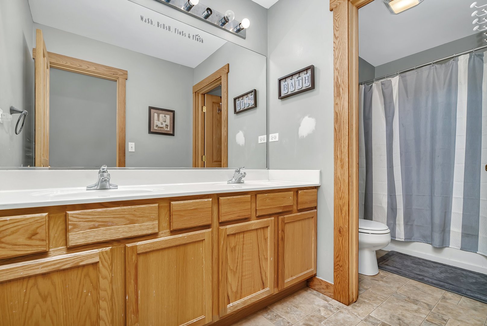 27039 West Hemlock Road Channahon, IL 60410 - Photo 30 of 41 a bathroom with a double vanity sink and a mirror
