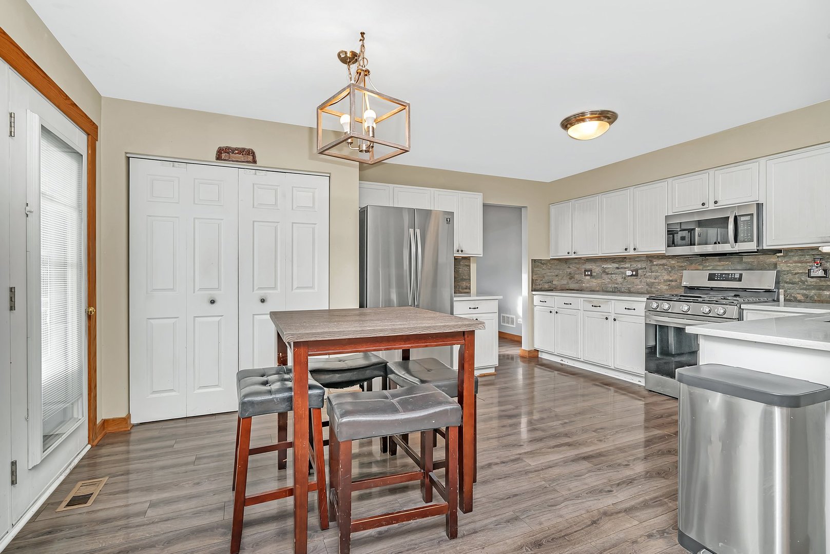 27039 West Hemlock Road Channahon, IL 60410 - Photo 10 of 41 a kitchen with stainless steel appliances a dining table chairs and wooden floor