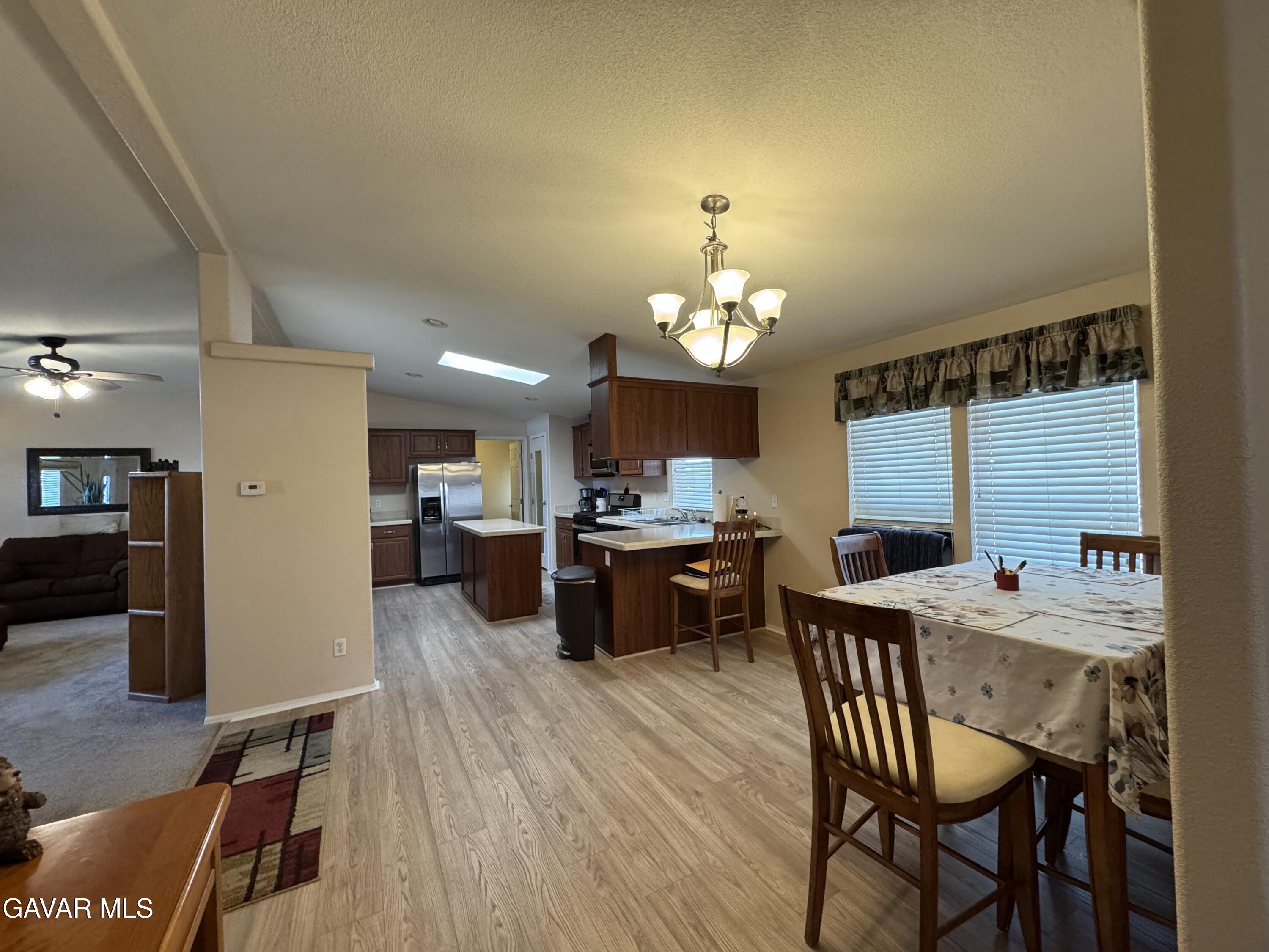 2000 Windflow Drive Rosamond, CA 93560 - Photo 16 of 48 a view of a dining room with furniture and wooden floor