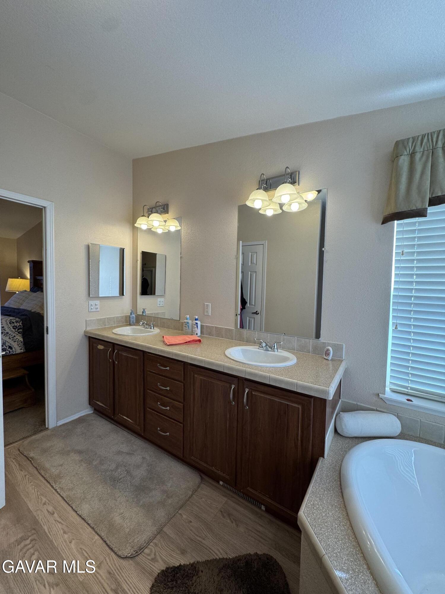 2000 Windflow Drive Rosamond, CA 93560 - Photo 26 of 48 a large bathroom with a double vanity sink and a mirror