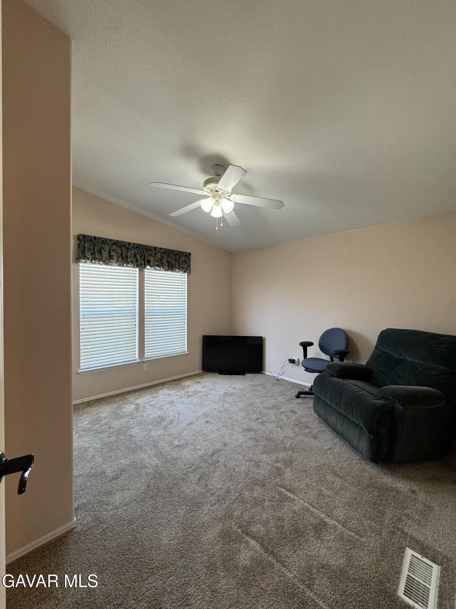 2000 Windflow Drive Rosamond, CA 93560 - Photo 27 of 48 a living room with furniture and a large window