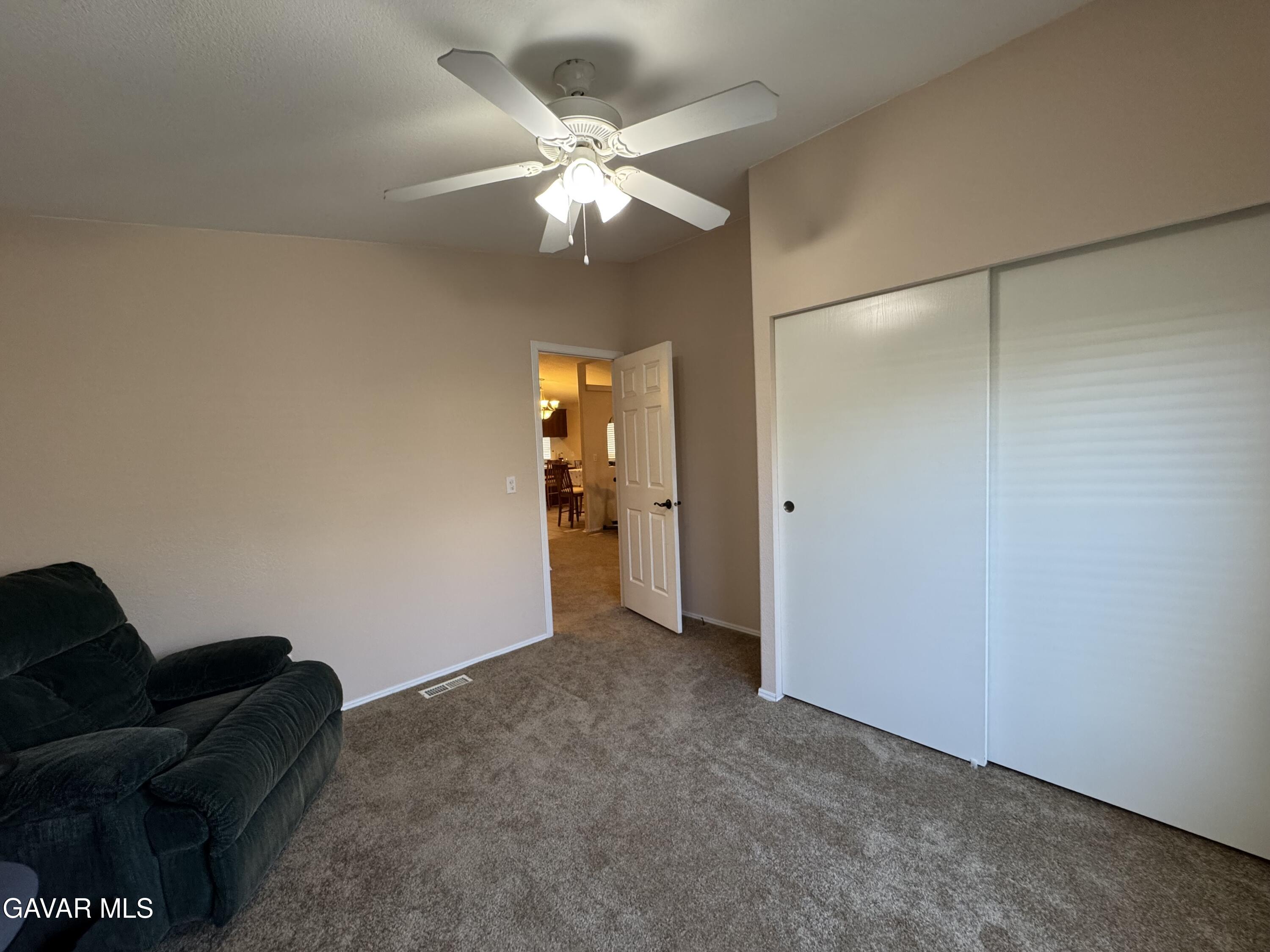 2000 Windflow Drive Rosamond, CA 93560 - Photo 28 of 48 an empty room with closet and a chandelier fan