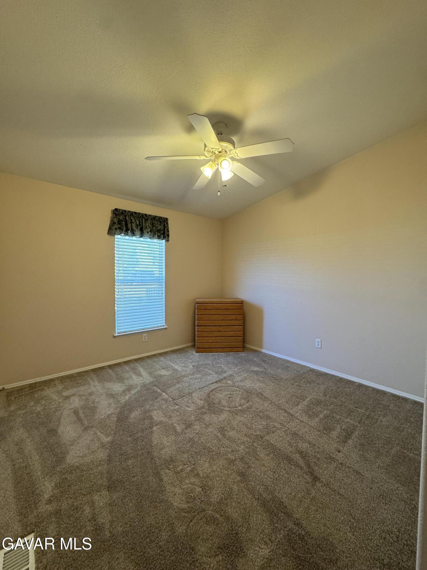 2000 Windflow Drive Rosamond, CA 93560 - Photo 29 of 48 a view of an empty room and chandelier fan