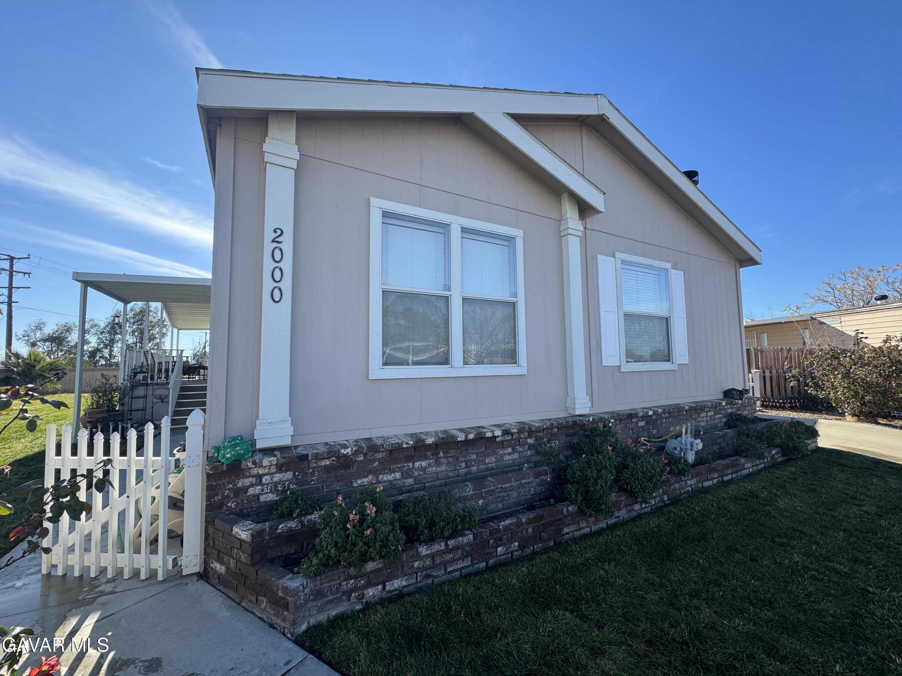 2000 Windflow Drive Rosamond, CA 93560 - Photo 3 of 48 a front view of a house with garden