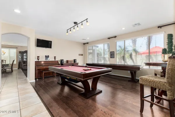 a living room with furniture a flat screen tv and a large window