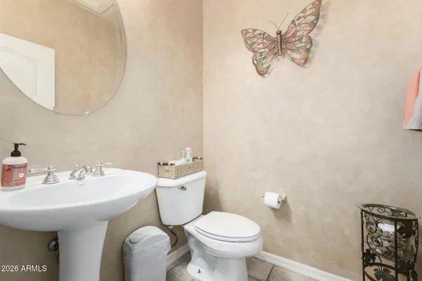 a bathroom with a sink mirror and toilet