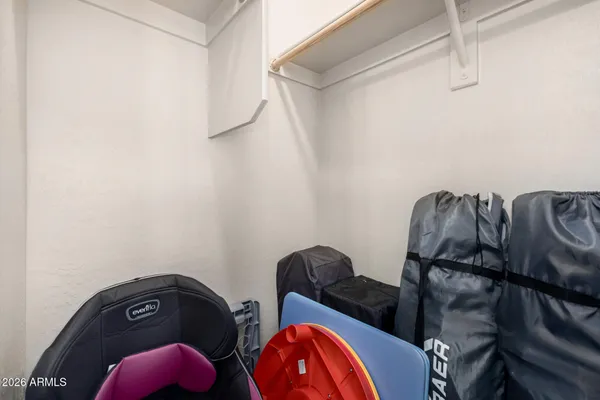 a view of walk in closet with clothes and shoes