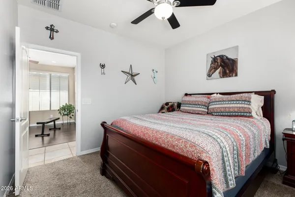 a bedroom with bed and a chandelier