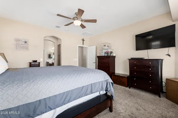 a bedroom with a bed and a flat screen tv