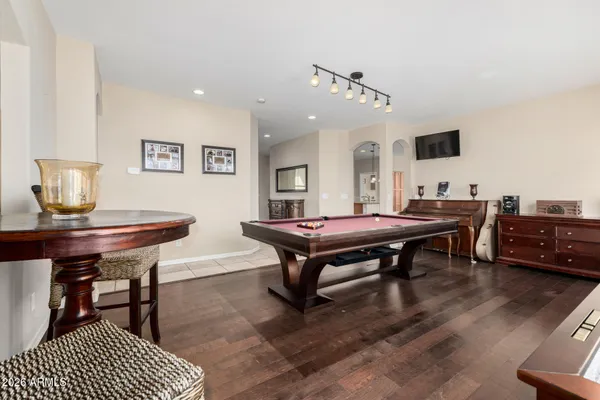 a room with furniture pool table and windows