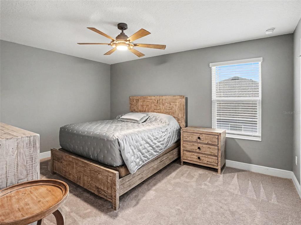 5270 Obsidian Gate Road Mount Dora, FL 32757 - Photo 35 of 50 a bedroom with a bed and a chandelier