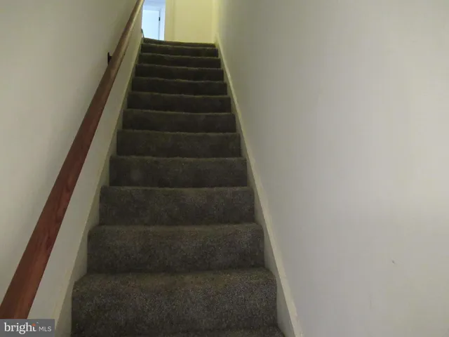 a view of an empty room with window and a fireplace