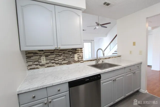 a kitchen with a sink and cabinets
