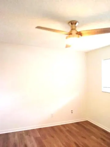 a view of an empty room and wooden floor