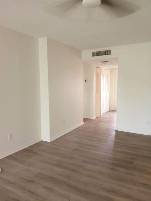 6300 Northwest 62nd Street, Unit 303 Pompano Beach, FL 33068 - Photo 4 of 11 a view of an empty room and wooden floor