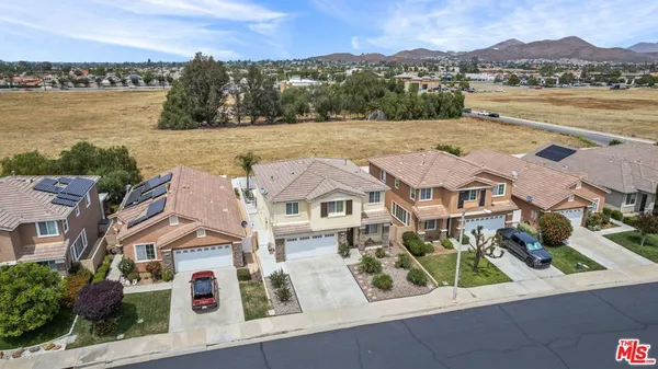 an aerial view of residential houses with outdoor space and river