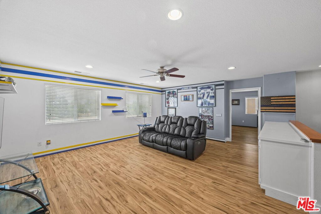 26692 Rim Creek Path, Unit PATHWAY Menifee, CA 92584 - Photo 18 of 41 a living room with furniture and a wooden floor