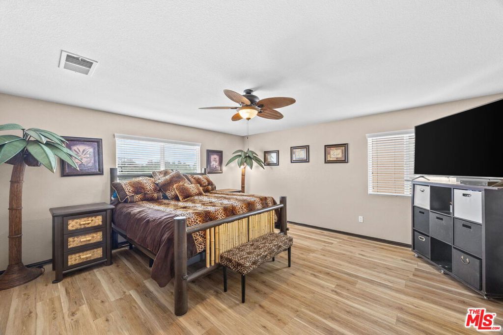 26692 Rim Creek Path, Unit PATHWAY Menifee, CA 92584 - Photo 19 of 41 a bedroom with furniture and a flat screen tv