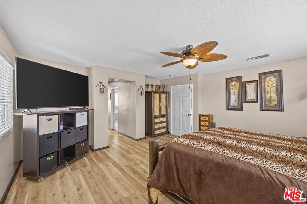 26692 Rim Creek Path, Unit PATHWAY Menifee, CA 92584 - Photo 20 of 41 a bedroom with furniture and a flat screen tv