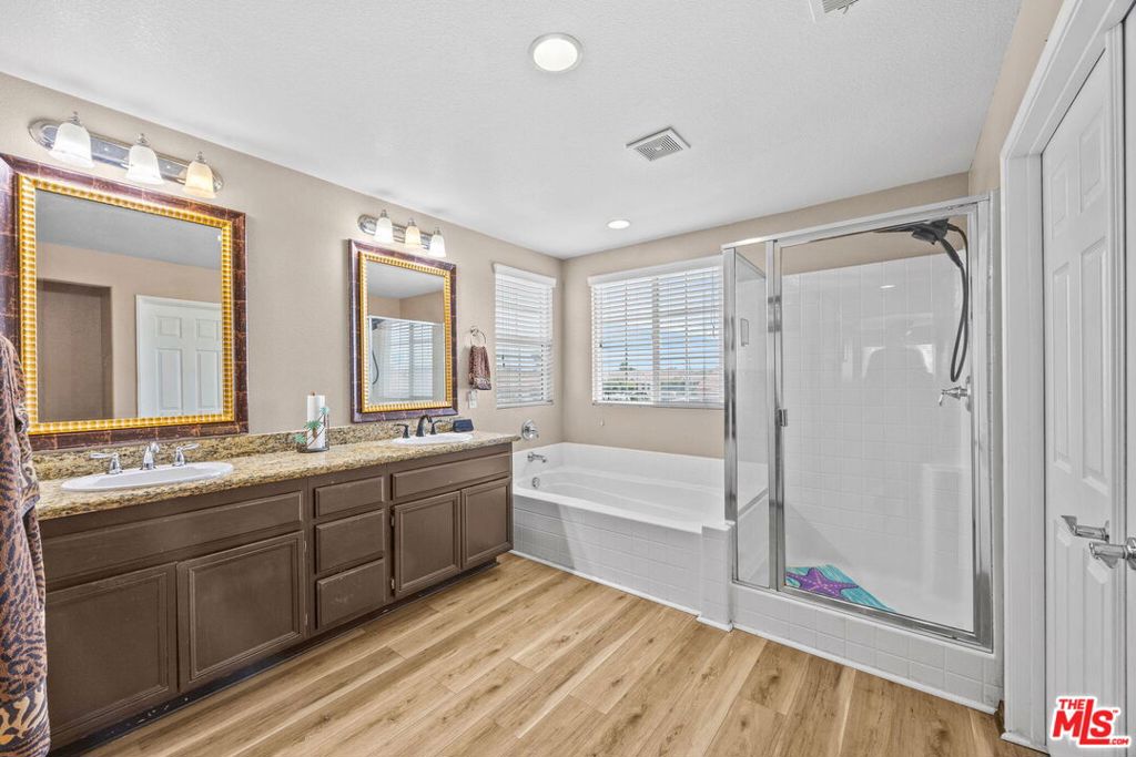 26692 Rim Creek Path, Unit PATHWAY Menifee, CA 92584 - Photo 23 of 41 a large bathroom with a large tub and shower