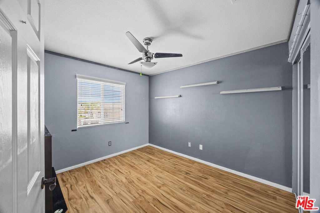 26692 Rim Creek Path, Unit PATHWAY Menifee, CA 92584 - Photo 27 of 41 a bedroom with a bed and a ceiling fan