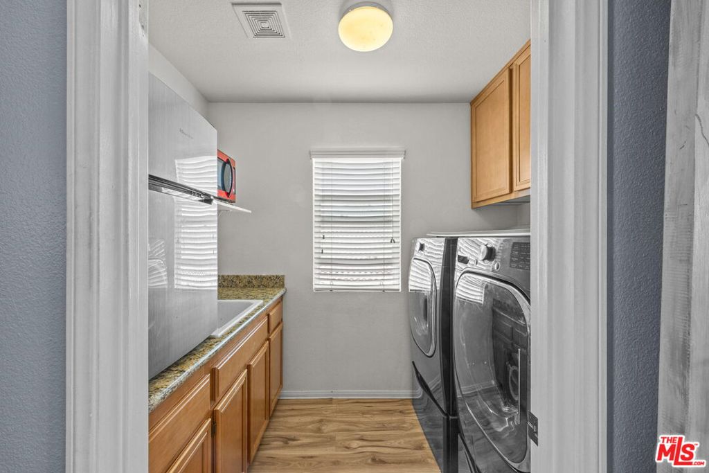 26692 Rim Creek Path, Unit PATHWAY Menifee, CA 92584 - Photo 28 of 41 a view of storage and utility room with washer and dryer