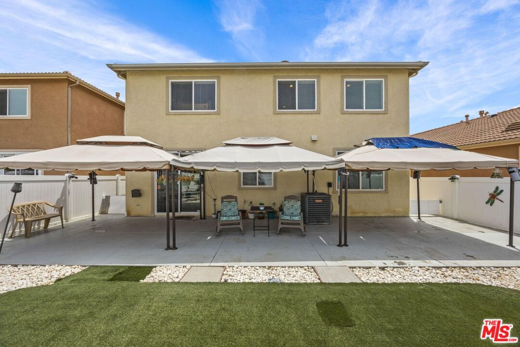 26692 Rim Creek Path, Unit PATHWAY Menifee, CA 92584 - Photo 32 of 41 a patio with table and chairs