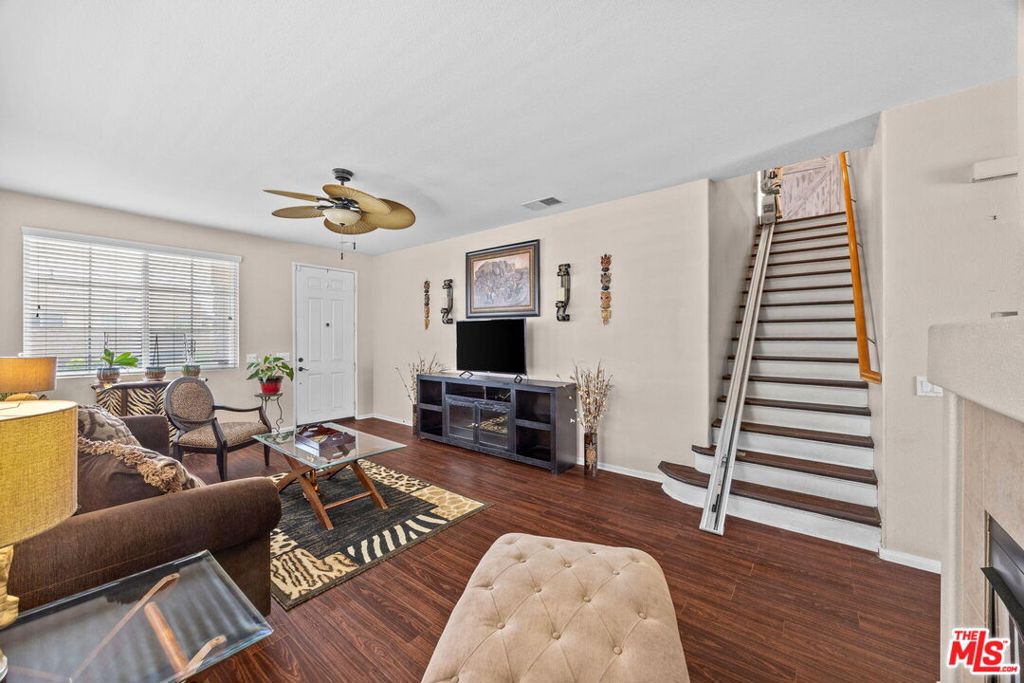 26692 Rim Creek Path, Unit PATHWAY Menifee, CA 92584 - Photo 6 of 41 a living room with furniture and a flat screen tv
