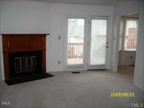 a view of an empty room with a fireplace