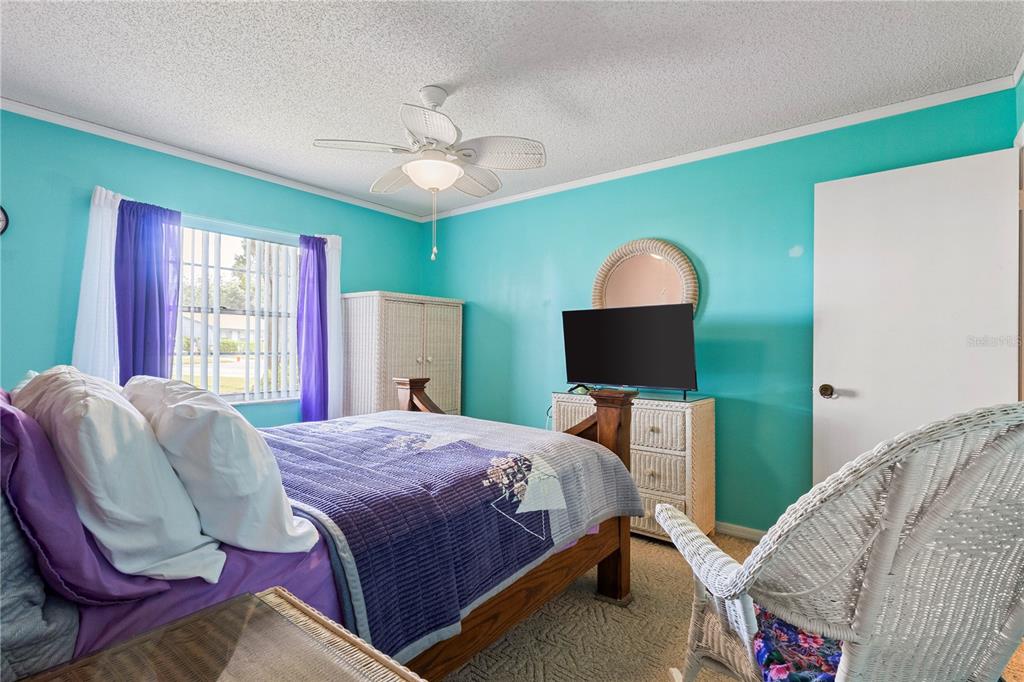 409 Feltham Trail, Unit B Sun City Center, FL 33573 - Photo 16 of 34 a bedroom with a bed and a window
